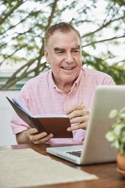 Positive Senior Man Video Calling Business Partner Taking Notes — Stock Photo, Image
