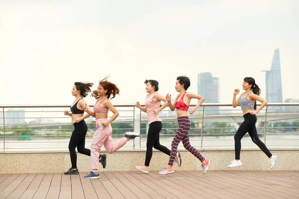 Side View Modern Ethnic Women Team Jogging Together Waterfront City — Stock Photo, Image