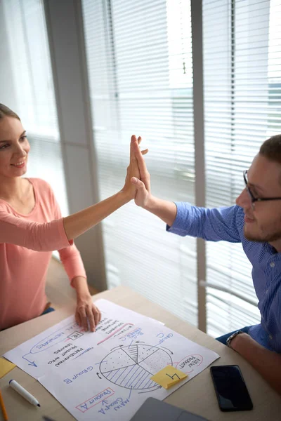 Happy successful project managers giving each other high five