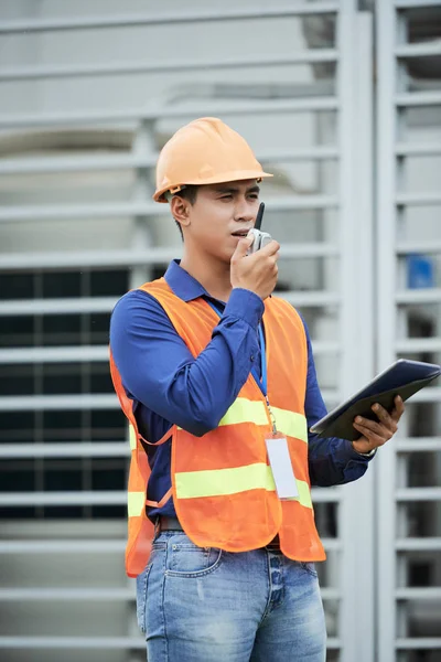 Attractive Asian Man Hardhat Waistcoat Looking Away Talking Walkie Talkie — Stock Photo, Image