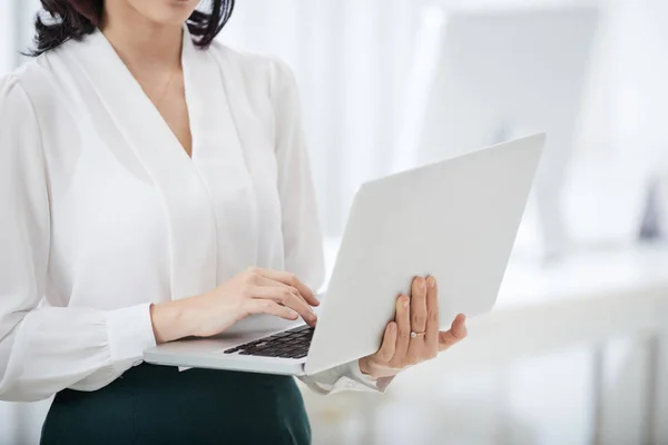 Foto Sin Rostro Elegante Mujer Negocios Sosteniendo Ordenador Portátil Escribiendo — Foto de Stock