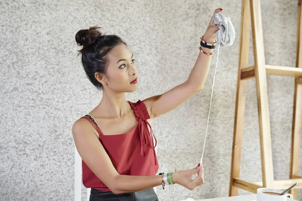 Joven Diseñadora Asiática Pie Examinando Cinta Plata Sus Manos Taller —  Fotos de Stock