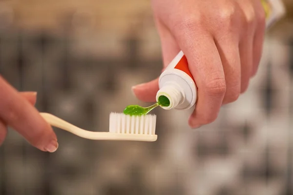 Close Female Hands Holding Toothbrush Applying Green Toothpaste Bathroom — Stock Photo, Image