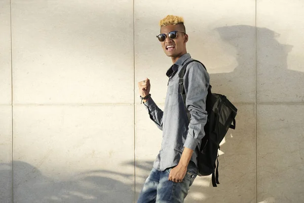 Cheerful Black college student in sunglasses celebrating success