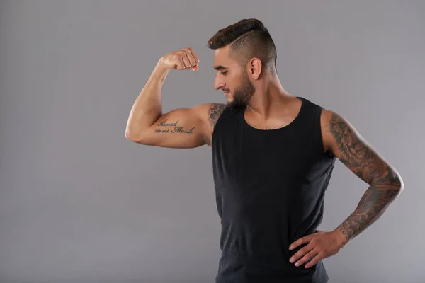 Young Tattooed Man Black Tank Top Standing Gray Background Showing — Stock Photo, Image