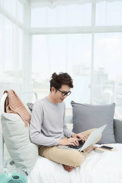 Young Man Sitting Comfy Bed Working Laptop — Stock Photo, Image