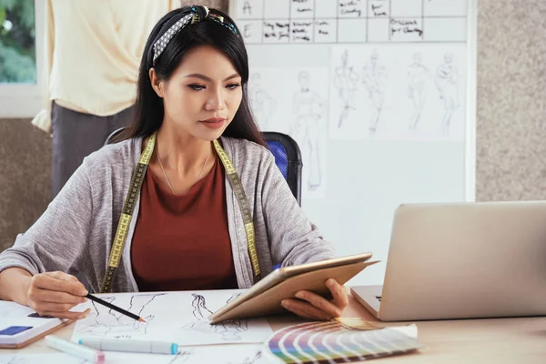 Pretty Creative Vietnamese Fashion Designer Reading Something Tablet Computer Drawing — Stock Photo, Image