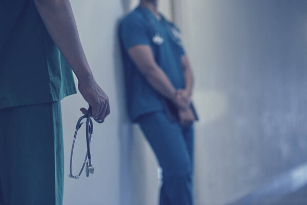 Cropped image of doctor stressed after talking to dying patient