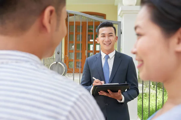 专业房地产经纪人与年轻已婚夫妇会面 — 图库照片