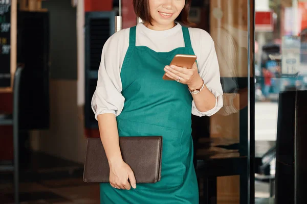 Cameriera Sorridente Con Menu Nelle Sue Mani Sms Amico Durante — Foto Stock