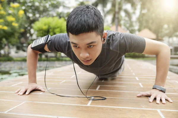 Serious Young Vietnamese Man Doing Press Ups Outdoors — Stock Photo, Image