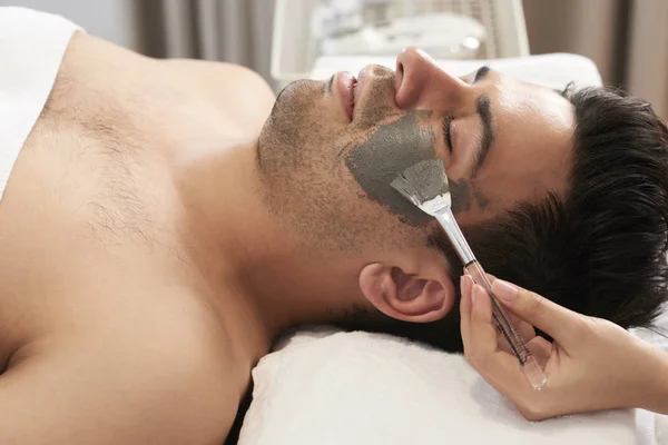 Young Man Lying Bed His Eyes Closed While Cosmetologist Applying — Stock Photo, Image