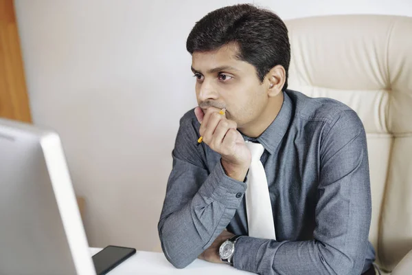 Portrait Pensive Indian Businessman Covering His Mouth Hand Reading Article — Stock Photo, Image