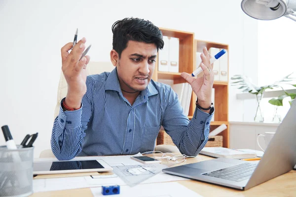 Frustrated angry Indian engineer reading mail from client