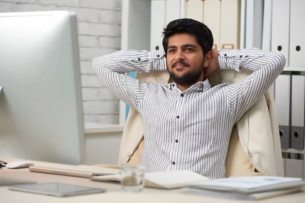 笑顔の夢のようなインドのビジネスマンは彼の椅子にもたれかかって 短い休憩の間にリラックス — ストック写真