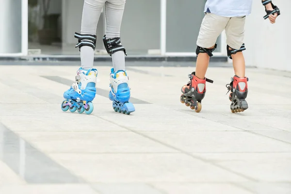 Back View Two Children Riding Roller Skates Cement Path Together — Stock Photo, Image
