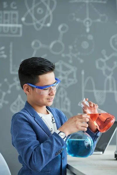 Smiling Asian Schoolboy Mixing Red Blue Liquids — Stock Photo, Image