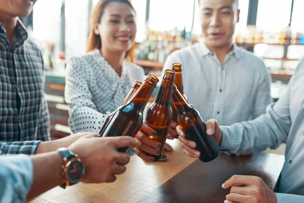 Crop People Gathering Together Clinking Beer Bottles Toasting Success Bar — Stock Photo, Image