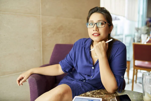 Portrait of pretty confident Indian business lady in glasses