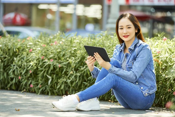 Portrait Young Vietnamese Woman Denim Clothes Reading Outdoor Digital Tablet — Stock Photo, Image