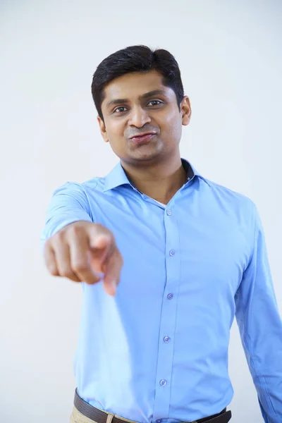 Portrait Mature Indian Businessman Standing Blue Shirt Pointing Camera White — Stock Photo, Image