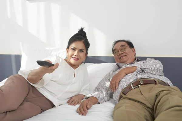 Pareja Vietnamita Envejecida Positiva Relajándose Cama Habitación Del Hotel Viendo —  Fotos de Stock