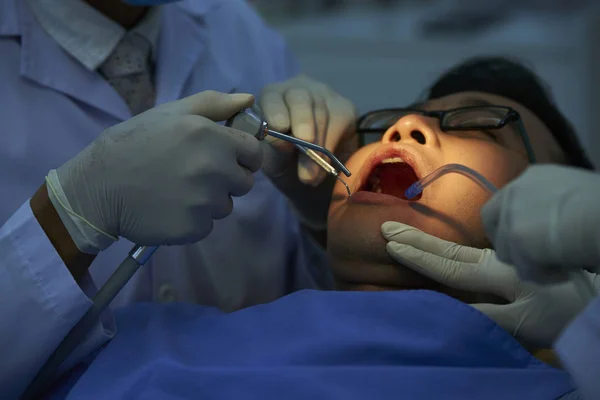 Пациент Лежит Открытым Ртом Пока Два Стоматолога Проверяют Зубы Сверлят — стоковое фото