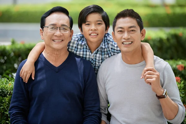Cheerful Vietnamese Boy Hugging His Father Grandfather — Stock Photo, Image