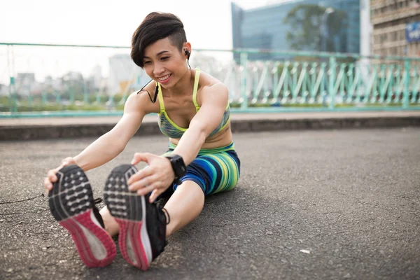 Cheerful Young Vietnamese Woman Stretching Forward Touching Her Feet — Stock Photo, Image