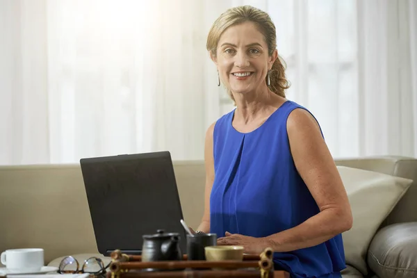 Porträtt Mogen Kvinna Sitter Soffan Vardagsrummet Med Laptop Och Leende — Stockfoto