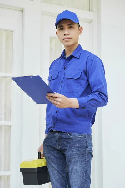 Portrait Young Asian Repairman Uniform Holding Toolbox Clipboard Standing Door — Stock Photo, Image