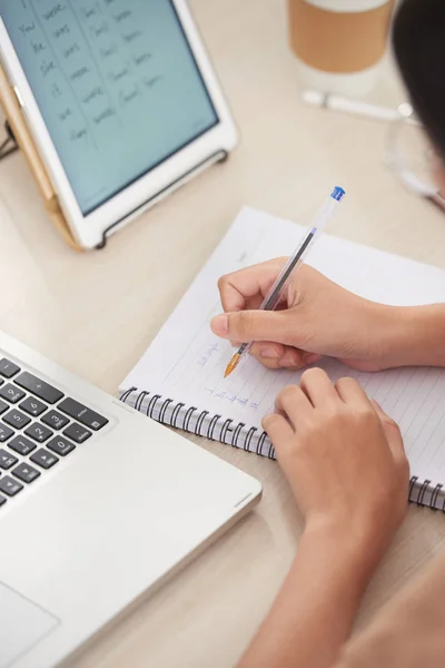 Crop View Female Writing Chart Tablet Notepad Sitting Wooden Desk — Stock Photo, Image