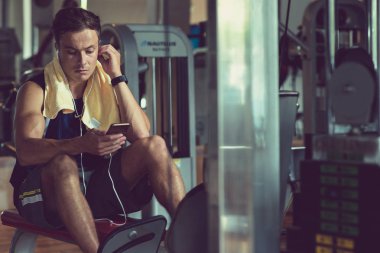 Spor salonunda eğitim sırasında dinlemek için müzik seçerek Ciddi uygun adam