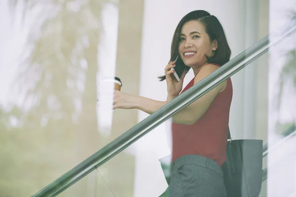 Smiling Asian Manager Drinking Coffee Has Conversation Mobile Phone Office — Stock Photo, Image