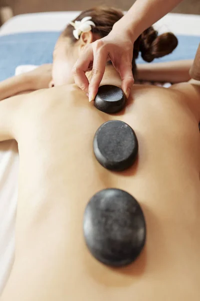 Spa Salon Worker Putting Hot Basalt Stones Spine Young Female — Stock Photo, Image