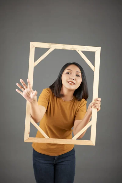 年轻的亚洲女人拿着木制相框 伸出她的手拿东西 — 图库照片