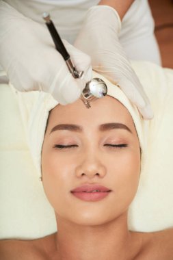 Özel ekipman ile kozmetolojist tarafından yapılan güzel kaşları ile Asya güzel yüz yakın çekim