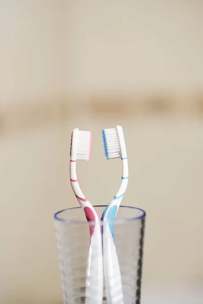 Pair Blue Pink Toothbrushes Love Concept Glass Cup Bathroom — Stock Photo, Image
