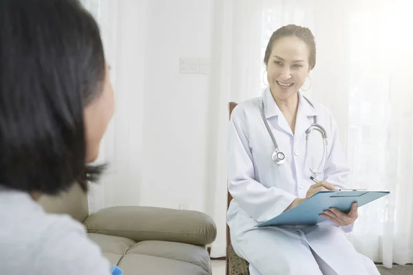 Smiling Asian Female Doctor White Coat Sitting Chair Prescribing Medicine — Stock Photo, Image