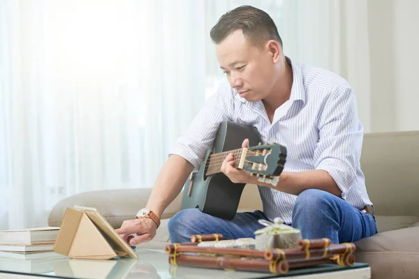 Serious Middle Aged Man Sitting Sofa Using His Tablet While — Stock Photo, Image