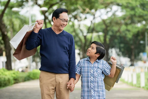 Sweet Asian Boy Smiling Looking Grandfather While Walking Park Together — Stock Photo, Image