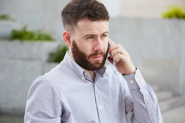 Serious Bearded Male Executive Has Business Talk Mobile Phone Standing — Stock Photo, Image