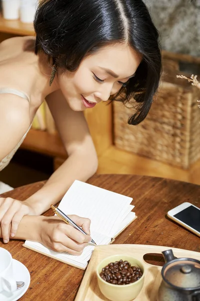 Positive Young Vietnamese Woman Having Morning Coffee Writing Plans Day — Stock Photo, Image