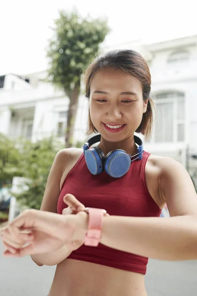 Positive Pretty Young Vietnamese Woman Checking Notifications Her Smart Watch — Stock Photo, Image