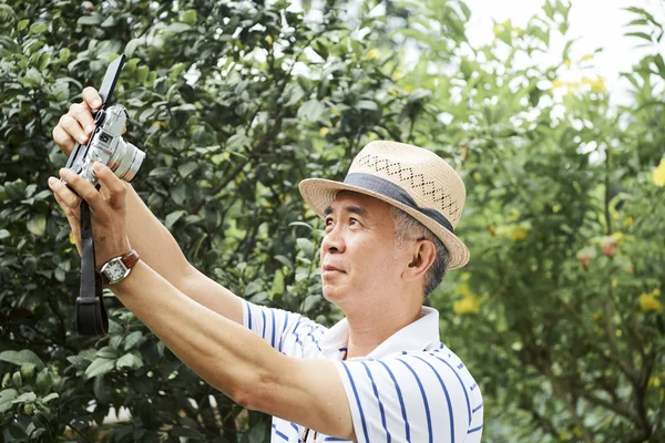 Asian Senior Man Holding Digital Camera Front His Face Making — Stock Photo, Image