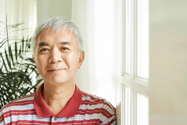 Portrait Asian Mature Man Standing Window Home Looking Camera Smile — Stock Photo, Image