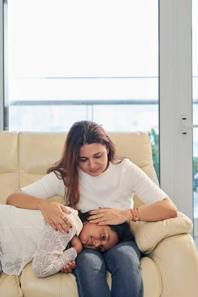 Young Mother Stroking Her Daughter Head While She Lying Her — Stock Photo, Image