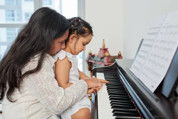 Giovane Ragazza Seduta Insieme Con Bambina Mostrandole Come Suonare Pianoforte — Foto Stock