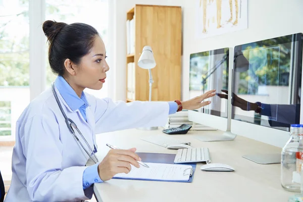 Asiática Jovem Radiologista Sentado Mesa Trabalhando Com Documentos Apontando Para — Fotografia de Stock