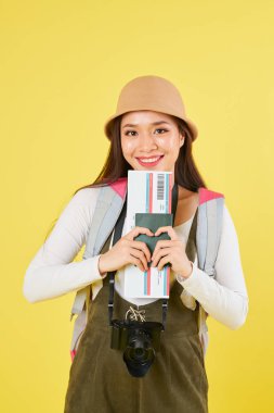 Uluslararası pasaport ve biniş kartı tutan panama şapka lovely gülümseyen genç Vietnamlı gezgin